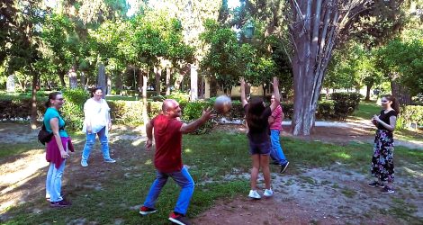 Families playing an ancient Greek ball game at the National Garden of Athens.