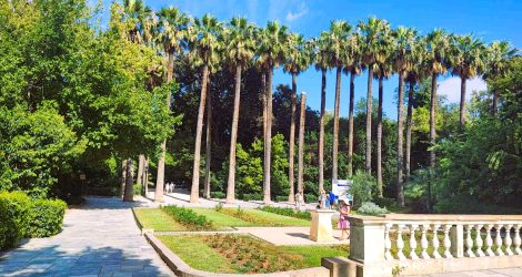 National Garden of Athens entrance with palm trees and sun clock.