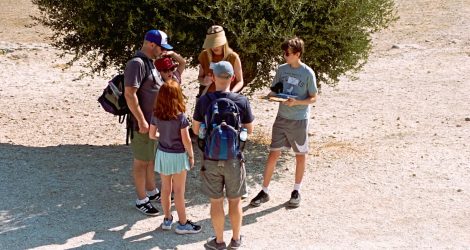 Family plays exploration game on Pnyx Hill during Nat Geo trip.