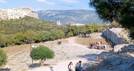 View of Pnyx Hill with speaker’s platform, Acropolis, and school group.